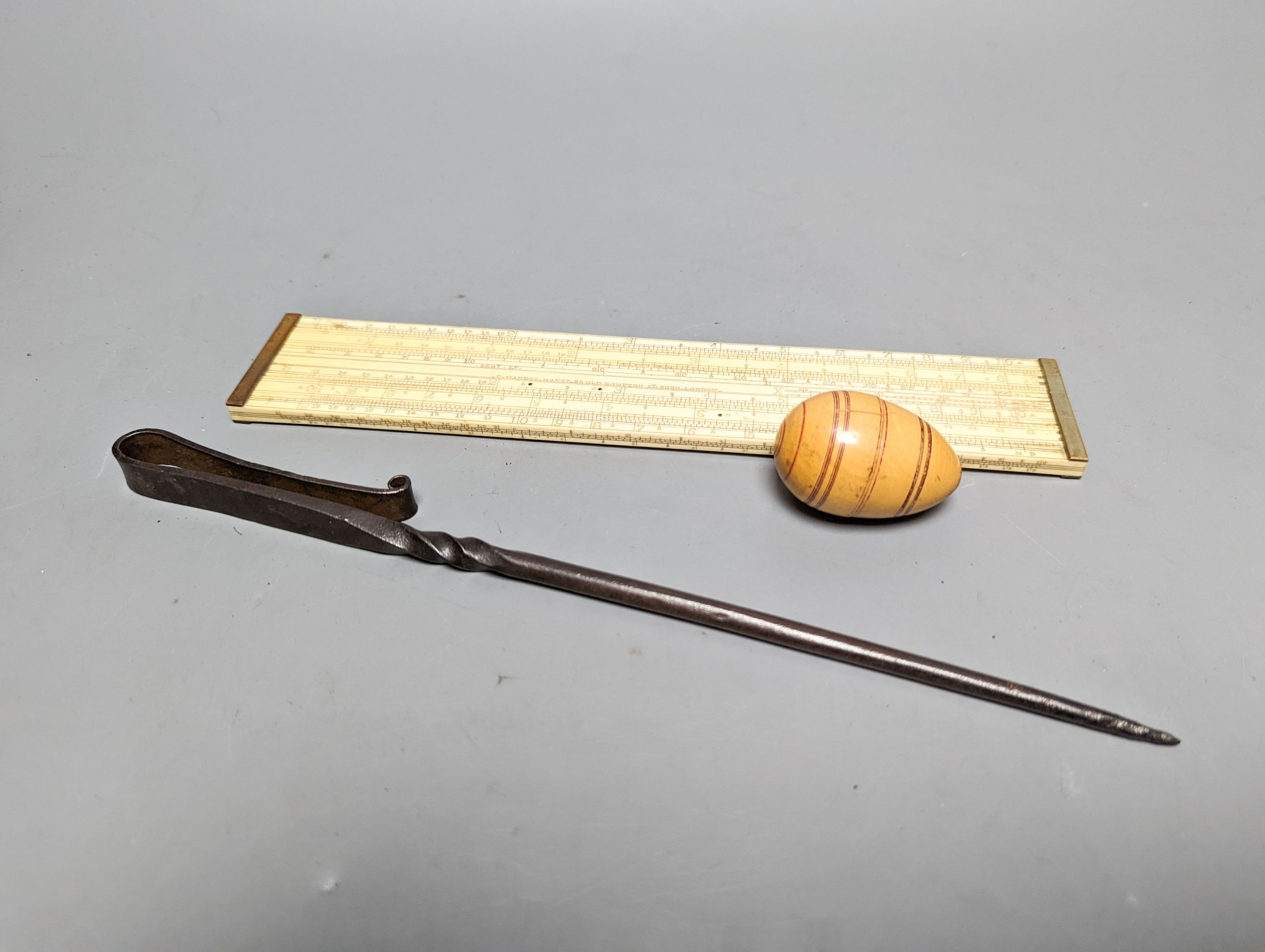 A Victorian ivory slide rule, by G. Manner, 25 Old Compton Street Soho London, 24cm, a nutmeg grater and a meat skewer